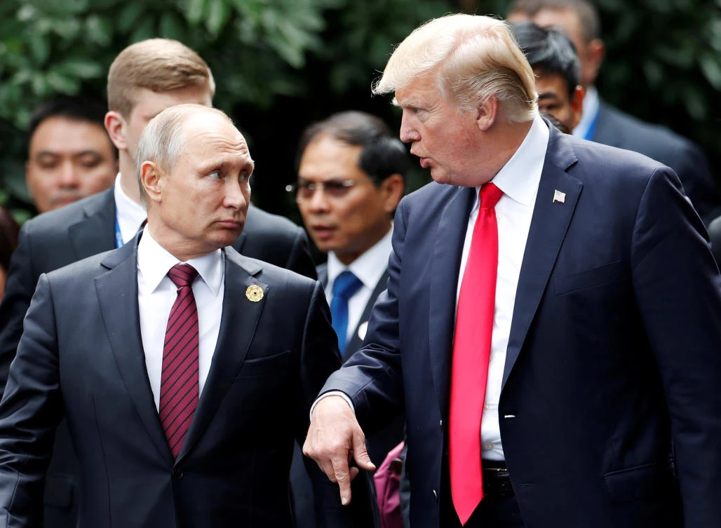 US President Donald Trump and Russia’s President Vladimir Putin talk during the family photo session at the APEC Summit in Danang, Vietnam. (Reuters)