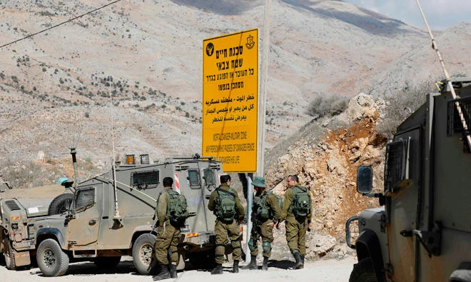 Israeli soldiers stand guard near the Israeli Syrian border next to the town of Majdal Shams in the Israeli-occupied sector of the Golan Heights on November 4, 2017, a day after an attack in the Syrian Druze village of Hader. (AFP)