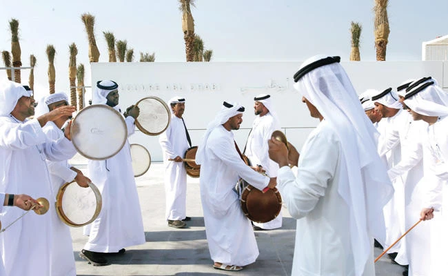 Traditional Emirati dancers perform at the entrance of the Louvre Museum during its public opening in Abu Dhabi on Saturday. (AP)