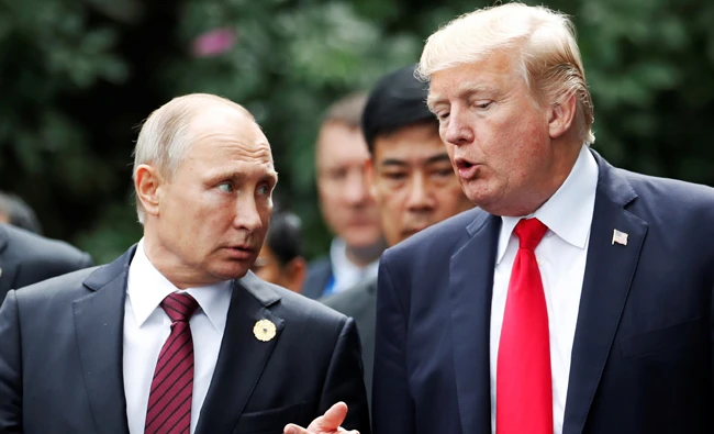 U.S. President Donald Trump and Russia's President Vladimir Putin talk during the family photo session at the APEC Summit in Danang, Vietnam on Saturday. (REUTERS)