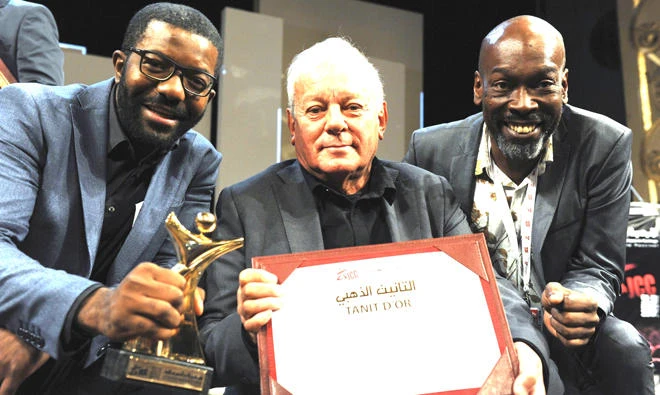 Writer and director Licinio Azevedo, center, flanked by actors Matamba Joaquim and Thiago Justino, poses after receiving the Golden Tanit award for his film ‘The Train of Salt and Sugar’ at the Carthage Film Festival
on Saturday. (AFP)