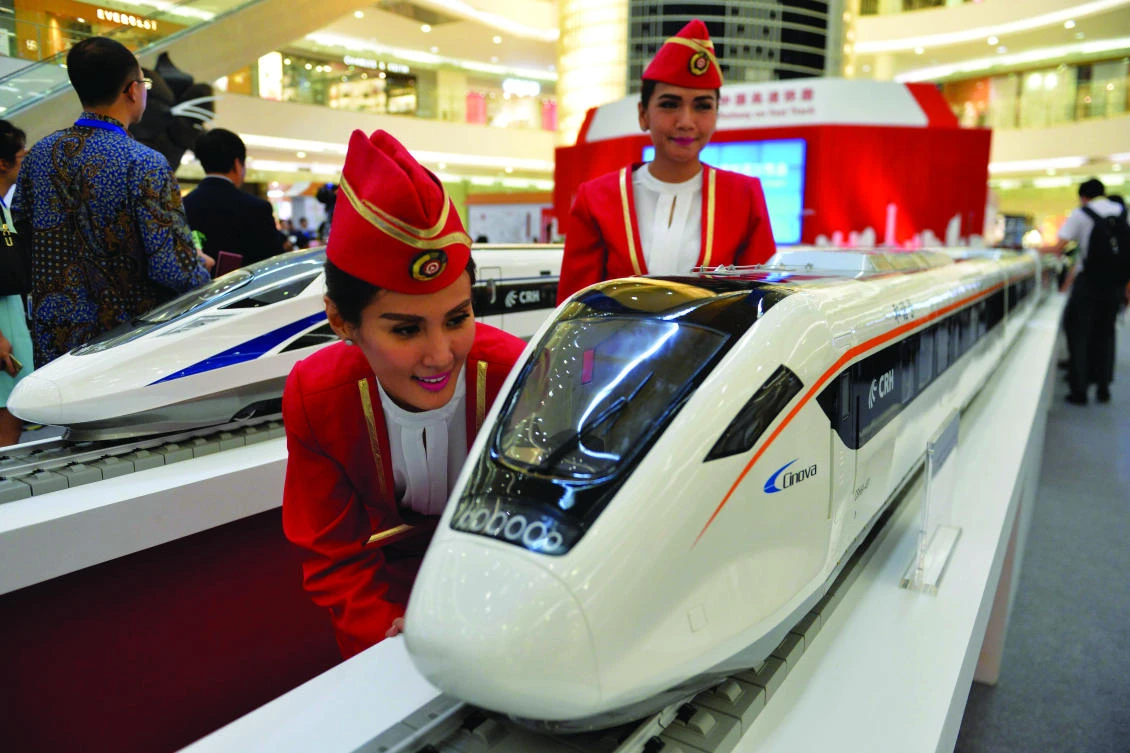 Indonesian models inspect scale models of Chinese-made bullet trains on exhibition at a shopping mall in Jakarta. From a stalled Indonesian rail project to an insurgency threatened economic corridor in Pakistan, China’s push to revive Silk Road trade routes is running into problems. (AFP)