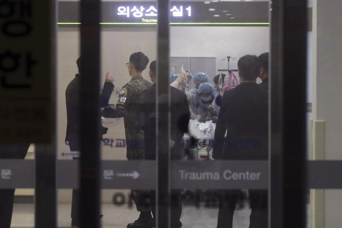 A South Korean army soldier, second from left, is seen as medical members treat an unidentified injured person, believed to be a North Korean soldier, at a hospital in Suwon, South Korea, Monday, Nov. 13, 2017. (Hong Ki-won/Yonhap via AP)