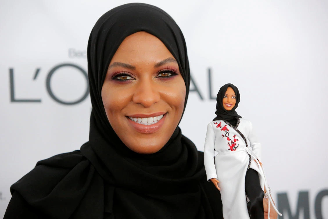 Olympic fencer IbtiHajj Muhammad holds a Barbie doll made in her likeness as she attends the 2017 Glamour Women of the Year Awards at the Kings Theater in Brooklyn, New York, US, November 13, 2017. (Reuters)