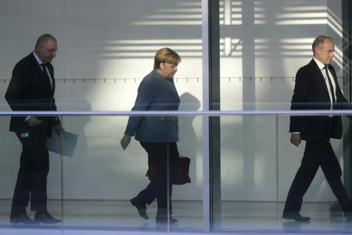German Chancellor Angela Merkel, center, arrives for talks about a possible new government coalition between her Christian Union parties block, CDU/CSU. with the Green Party and the Free Democratic Party, FDP, at the Reichstag building in Berlin, Germany, Tuesday, Nov. 7, 2017. (AP/Markus Schreiber)