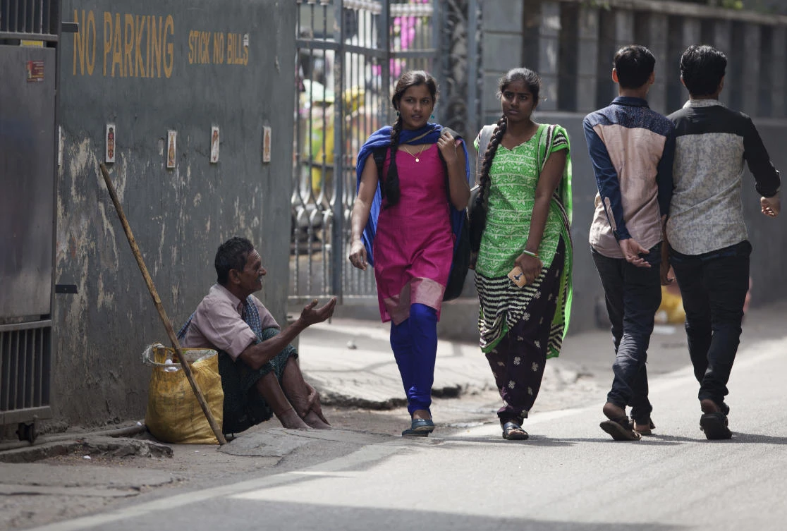 In this Monday, Nov. 13, 2017 photo, an Indian man seeks alms at a street in Hyderabad, India. Authorities in this southern Indian city are rounding up beggars ahead of a visit by Ivanka Trump. Over the past week, more than 200 beggars have been transported to separate male and female shelter homes located on the grounds of two city prisons. Officials say the drive against begging was launched because two international events are taking place in the city — the Global Entrepreneurship Summit and the World Telugu Conference in December. (AP/Mahesh Kumar A.)