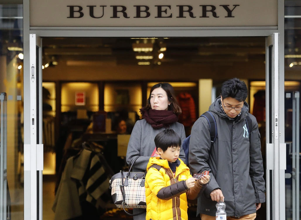 People leave a Burberry store in London. (AP/Frank Augstein/file)