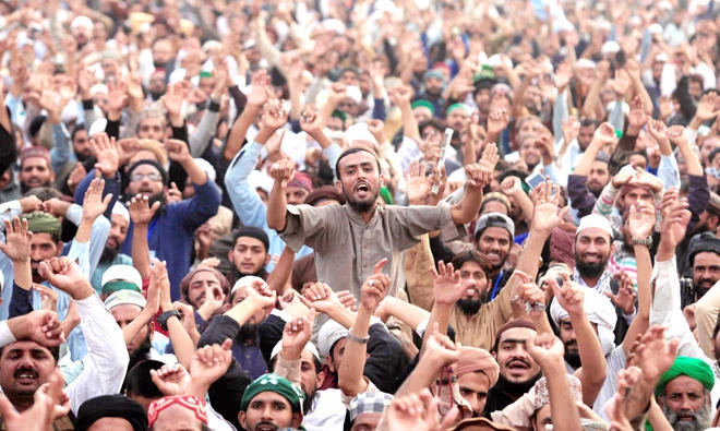 Members of the Tehreek-e-Labbaik Pakistan, a political party, shout slogans during a sit-in in Rawalpindi on Monday. (Reuters)