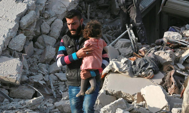 A Syrian man carries a child following a reported airstrike on the rebel-held town of Atareb in Syria's northern Aleppo province. Riyadh is to host a conference of Syrian opposition leaders on Nov.22 to 24. (AFP)