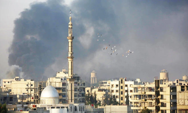 Smoke rises following an airstrike on the opposition-held besieged town of Harasta, in the Eastern Ghouta region on the outskirts of Damascus, on Tuesday. (AFP)