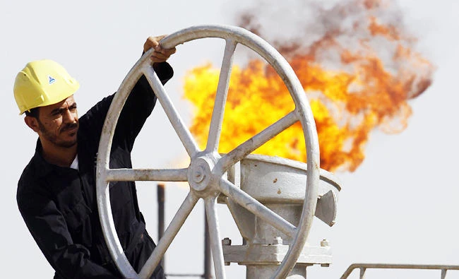 An Iraqi worker operates valves at the Nahran Omar oil refinery near the city of Basra in this file photo. (AP)