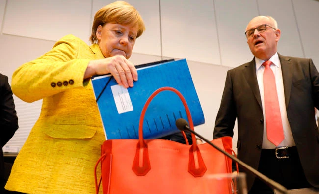 German Chancellor Angela Merkel and CDU/CSU parliamentary group leader Volker Kauder arrive for a meeting with the CDU/CSU parliamentary groups, in this November 6, 2017 photo, in Berlin. (AFP)