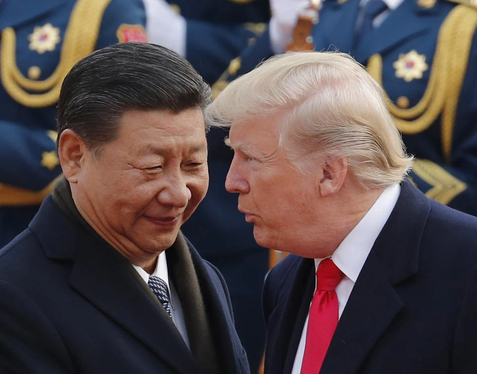 Donald Trump, right, chats with Chinese President Xi Jinping during a welcome ceremony for the US president at the Great Hall of the People in Beijing last week. (AP)