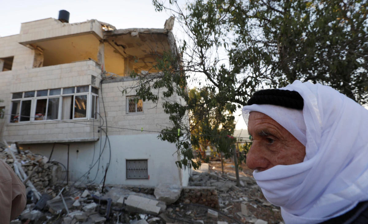 A man walks past the remains of the house of Palestinian assailant Nemr Al-Jamal after it was destroyed by Israeli troops in the West Bank village of Beit Surik near Jerusalem Nov. 15, 2017. (Reuters/Mohamad Torokman)