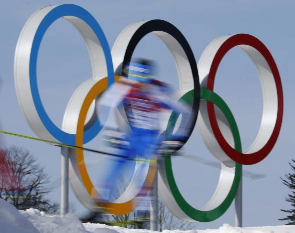 Athletes pass the Olympic rings during the men’s 50K cross-country race at the 2014 Winter Olympics in Krasnaya Polyana, Russia. World Anti-Doping Agency investigations into doping haven’t encouraged Russian athletes to speak out about abuses, but instead, there is a public hunt for whistleblowers, as Tuesday Nov. 14, 2017, Russia seems to move closer to a ban from the upcoming Winter Olympics.(AP/Dmitry Lovetsky, FILE)