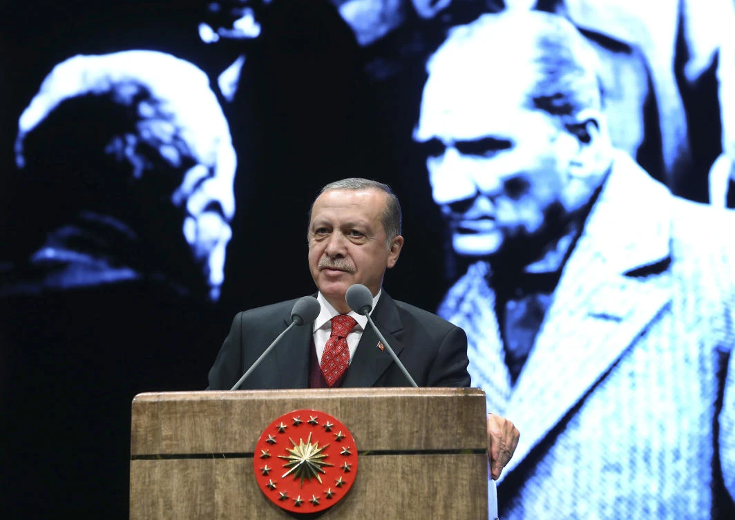 Turkey’s President Recep Tayyip Erdogan delivers a speech backdropped by an image of Turkey’s founding father Mustafa Kemal Ataturk, right during a ceremony to mark the 79th anniversary of Ataturk’s death, in Ankara, Turkey, Friday, Nov. 10, 2017. (Kayhan Ozer, Pool Photo via AP)