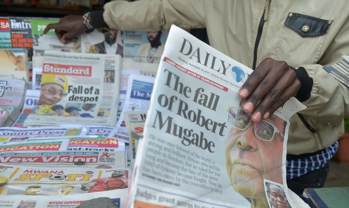 A newspaper vendor in Nairobi arranges local dailies with headlines about the situation in Zimbabwe on November 16. A joint statement by more than 100 civil society groups urged Robert Mugabe, the world’s oldest head of state, to peacefully step aside. (AFP)