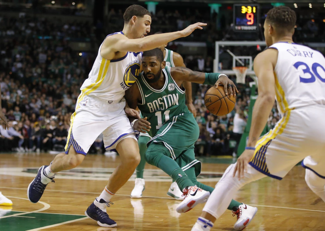 Above, Boston Celtics guard Kyrie Irving dribbles the ball as Golden State Warriors guard Klay Thompson defends in a showdown of the NBA’s top teams on Thursday. (USA TODAY Sports)