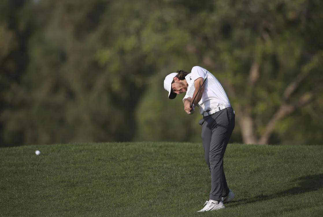 England’s Tommy Fleetwood plays a shot on the 14th hole during the first round of the DP World Tour Championship golf tournament in Dubai, United Arab Emirates, Thursday, Nov. 16, 2017. (AP Photo/Kamran Jebreili)