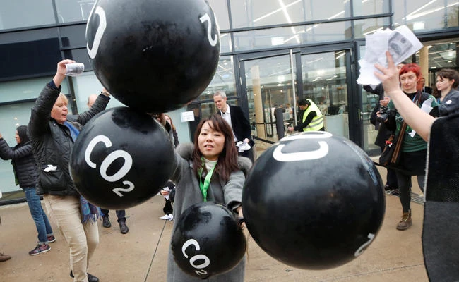 Activists protest against the carbon dioxide emissions trading in front of the World Congress Centre Bonn, the site of the COP23 U.N. Climate Change Conference, in Bonn, Germany, on Friday, November 17, 2017. (REUTERS/Wolfgang Rattay)