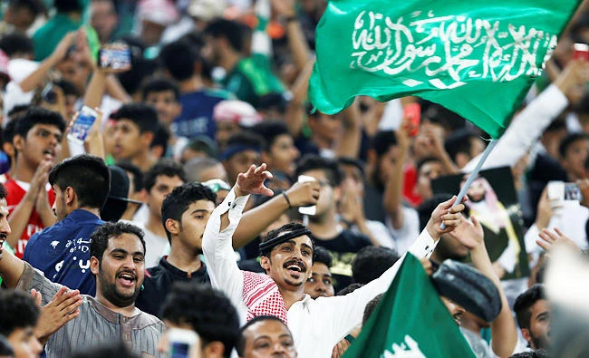 Fans of of Saudi Arabia cheer and chant before the start of their soccer match against Japan. (REUTERS)