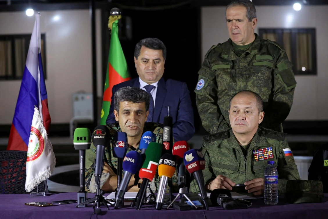 Nouri Mahmoud, spokesman of the Kurdish People's protection unit (YPG), speaks during a news conference with Russian Lieutenant General Alexei Kim as Abdel Karim Omar of the YPG and Russian Senator Ziyad Sabsabi stand, in Qamishli, Syria, on November 12, 2017. (REUTERS/Rodi Said)