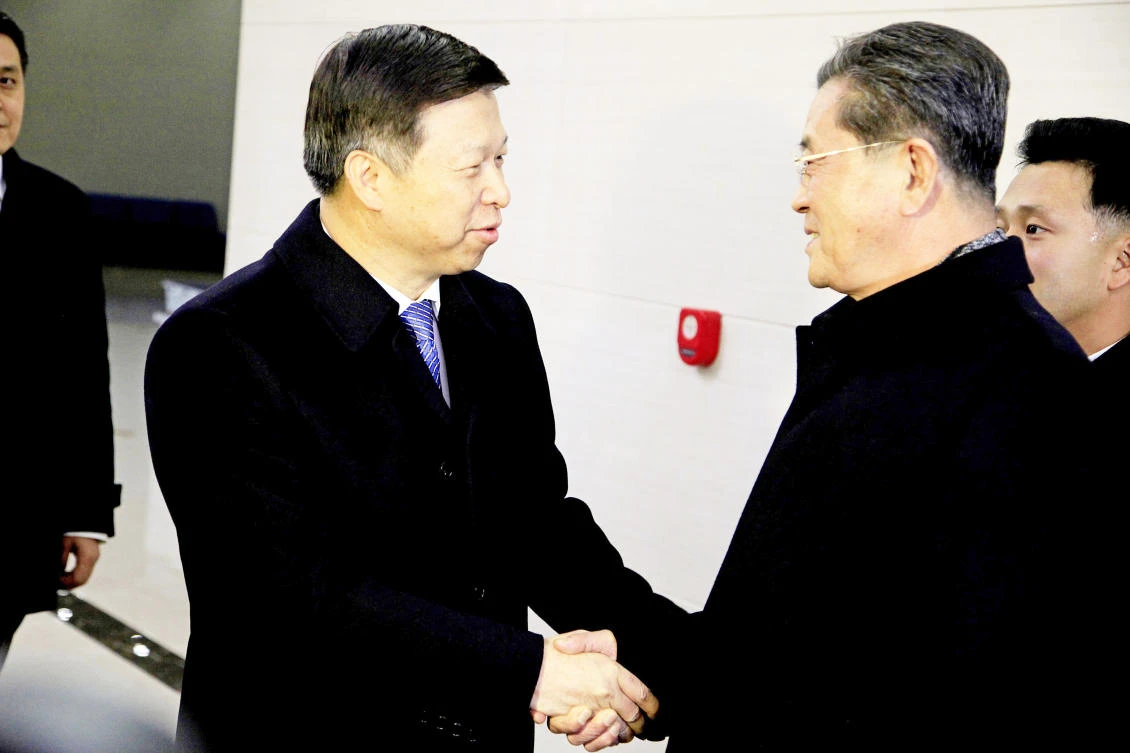 Chinese envoy Song Tao, left, is greeted by North Korean high official, Ri Chang Gun, after arriving with his delegation, Friday in Pyongyang, North Korea. (AP)