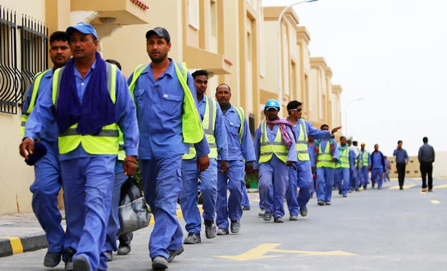 This file photo taken on May 4, 2015 shows foreign laborers working on the construction site of the al-Wakrah football stadium, one of the Qatar's 2022 World Cup stadiums, walking back to their accommodation at the Ezdan 40 compound after finishing work on May 4, 2015, in Doha's Al-Wakrah southern suburbs. (AFP)