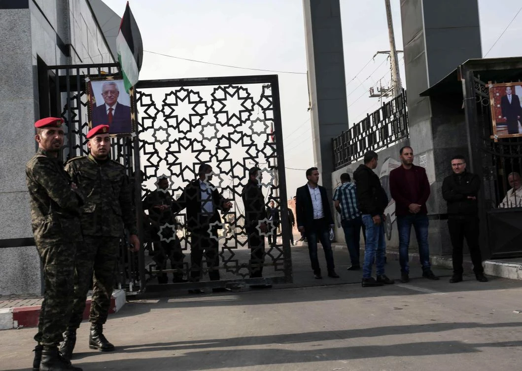 Palestinian security forces stand guard outside the Rafah border crossing with Egypt, which opened under the control of the Palestinian Authority for the first time since 2007. (AFP)