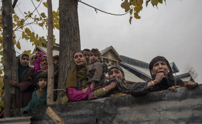 Kashmiri women grieve as they watch the funeral procession on Nov. 14, 2017 of a rebel killed in fighting with Indian troops. On Saturday, Nov. 18, 2017, six more suspected rebels were killed in a fierce gunfight with Indian troops. (AP Photo/Dar Yasin)