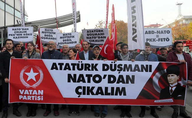Protestors wave flags and carry a banner during a demonstration against NATO military exercises on Nov. 18, 2017 in Ankara. (AFP / ADEM ALTAN)