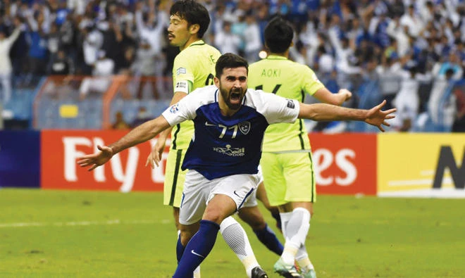 Syrian striker Omar Khribin wheels away in celebration after slotting home Al-Hilal’s equalizer against Urawa Reds. Inset: Urawa coach Takafumi Hori has defensive issues to address. (AFP)