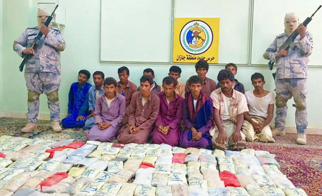 Saudi Border Guards detain infiltrators and display confiscated drugs. (AN photo)