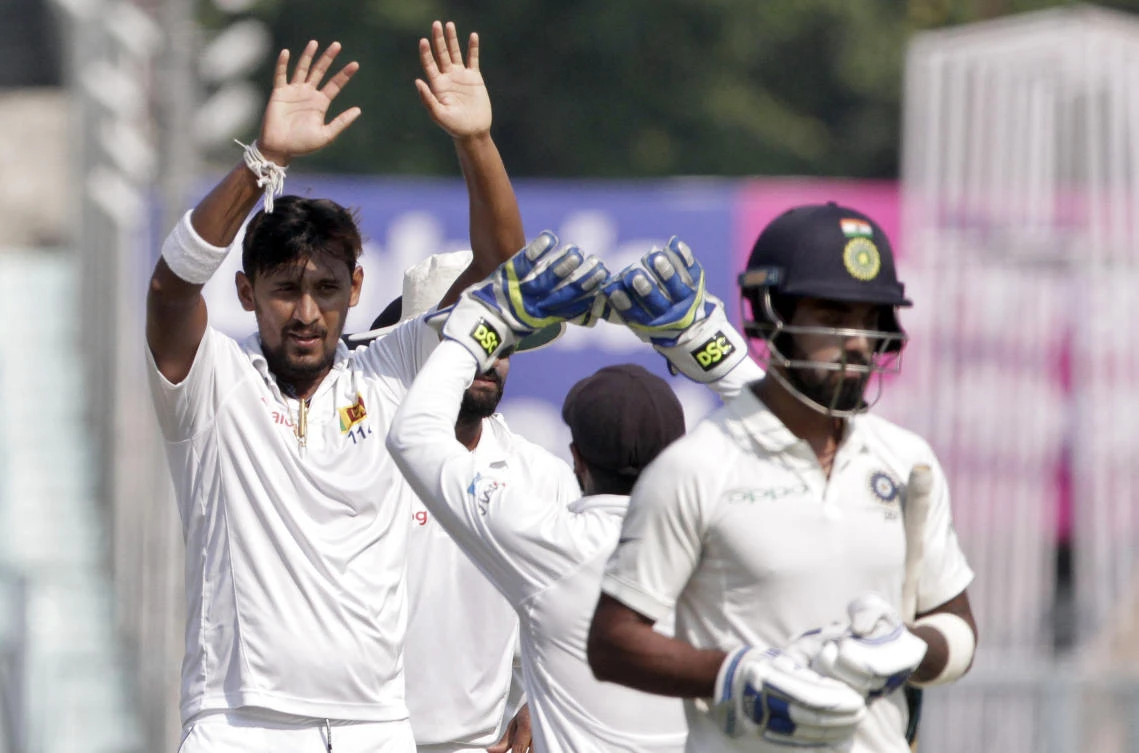 Sri Lanka’s Suranga Lakmal, left, celebrates the dismissal of India’s Lokesh Rahul, right, during the fifth day of their first test cricket match in Kolkata, India, Monday, Nov. 20, 2017. (AP Photo/Bikas Das)