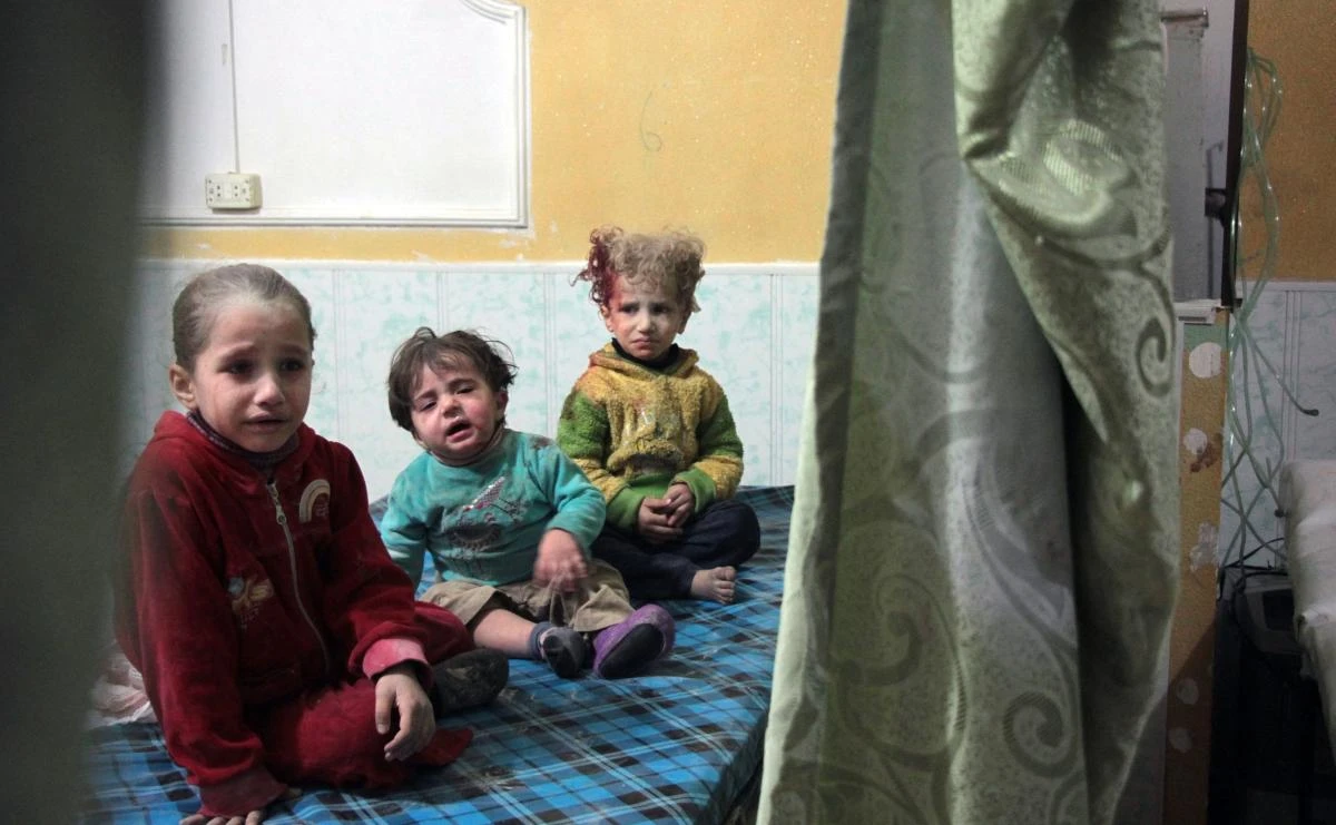 Syrian children sit at a makeshift clinic following reported shelling by Syrian government forces, in the rebel-held town of Douma in Syria’s eastern Ghouta region, on Nov. 17, 2017. Shelling by the Syrian regime on the rebel-held Eastern Ghouta, which has been besieged since 2013 and where humanitarian conditions are dire, killed at least 10 civilians, among them six children, the Syrian Observatory for Human Rights said. The deaths were the result of the latest bout in an escalating cycle of tit-for-tat attacks between regime forces and the rebels holding the enclave on the Syrian capital’s eastern outskirts. (AFP/Hamza Al-Ajweh)