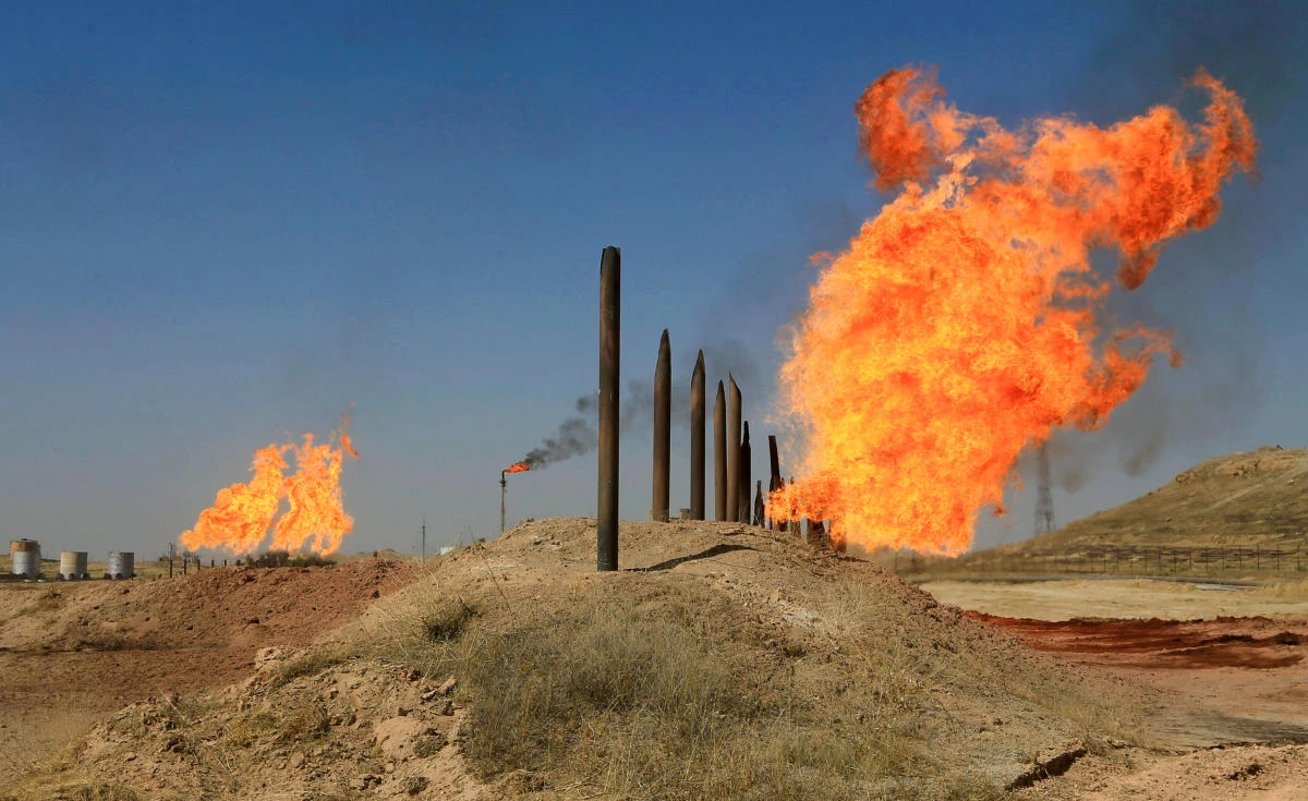 Above, flames emerge from flare stacks at the oil fields in Kirkuk. The drop in Kirkuk output helped to boost Iraqi and overall compliance with the deal. (Reuters)