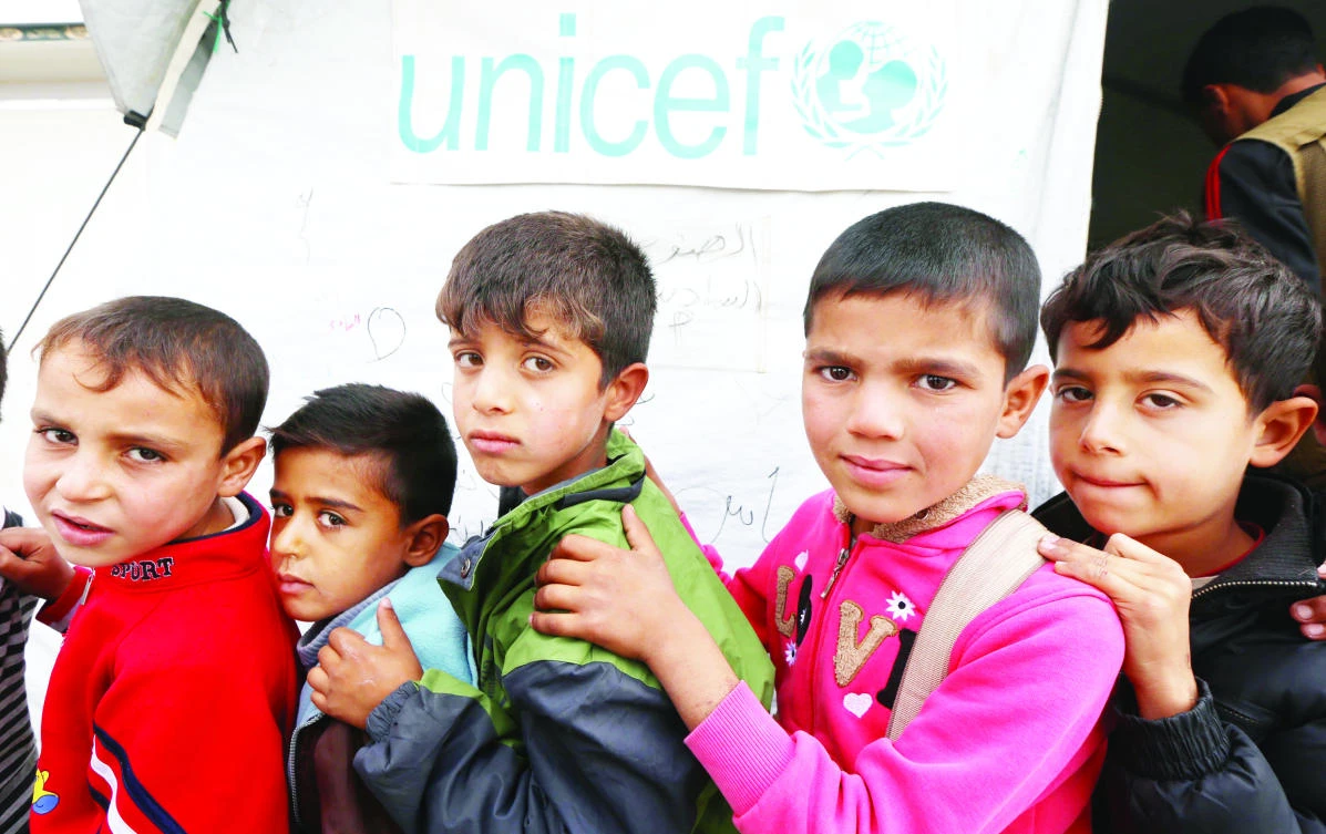 Displaced Iraqi children from the Mosul queue up on Monday outside a UN Children’s Fund school at the Hasan Sham camp, some 40 km east of Irbil in northern Iraq. (AFP)