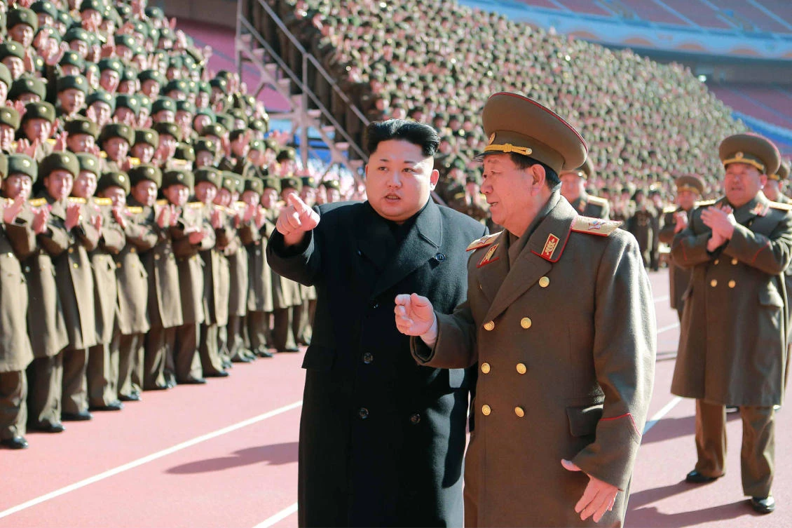 This undated file picture released from North Korea’s official Korean Central News Agency (KCNA) shows North Korean leader Kim Jong-Un (center L) speaking with Hwang Pyong-So (center R) as he meets with the participants in a meeting of military and political cadres at an undisclosed location in North Korea. (AFP/KCNA VIA KNS)