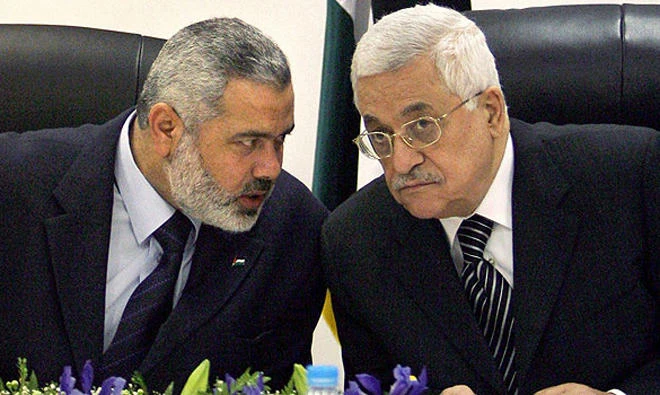 Palestinian President Mahmoud Abbas and Hamas chief Ismail Haniyeh speak during an event in Gaza City. (File photo/AP)