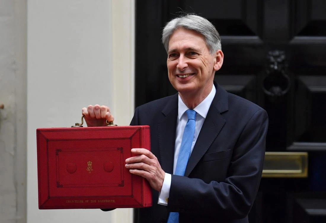 British Chancellor of the Exchequer Philip Hammond poses for pictures with the Budget Box as he leaves 11 Downing Street in London, on Nov. 22, 2017, before presenting the government’s annual Autumn budget to Parliament. (AFP/Ben Stansall)
