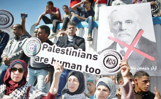 Palestinians protest in front of the Office of the United Nations Special Coordinator for the Middle East Peace Process headquarters, marking the 100th anniversary of the Balfour Declaration, in Gaza City, on Nov. 2, 2017. In London on Wednesday, scores of UK citizens from across the country descended upon Westminster to lobby their MPs to do more for Palestine. (AP Photo/ Khalil Hamra)