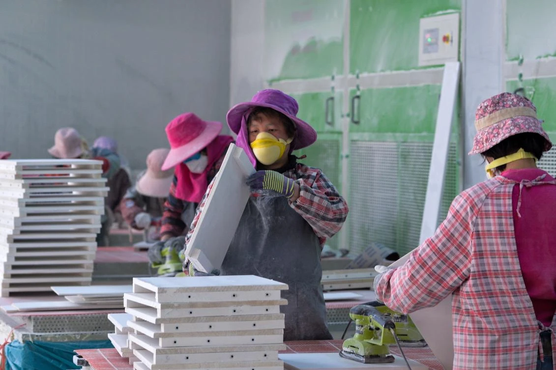 Workers are seen on Nov. 18, 2017 inside a furniture factory in a "Taobao Village" in Xuzhou in China's eastern Jiangsu province. (AFP / Chandan Khanna)