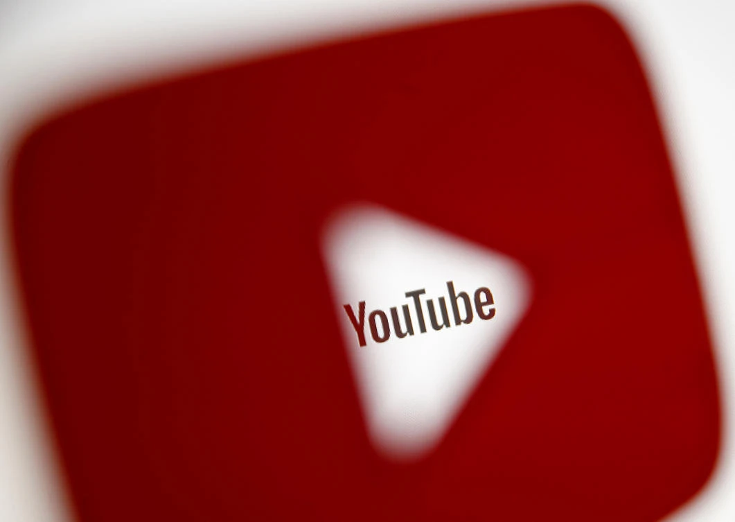 A 3D-printed YouTube icon is seen in front of a displayed YouTube logo in this illustration taken October 25, 2017. (REUTERS/Dado Ruvic/Ilustration/File Photo)