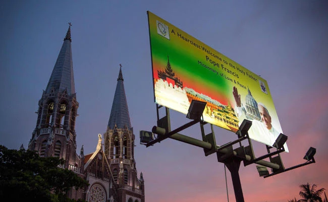 This photo taken on November 15, 2017 shows a signboard welcoming Pope Francis in front of the Catholic Church in Yangon. Pope Francis will visit Myanmar from November 27 to 30. (AFP / YE AUNG THU)