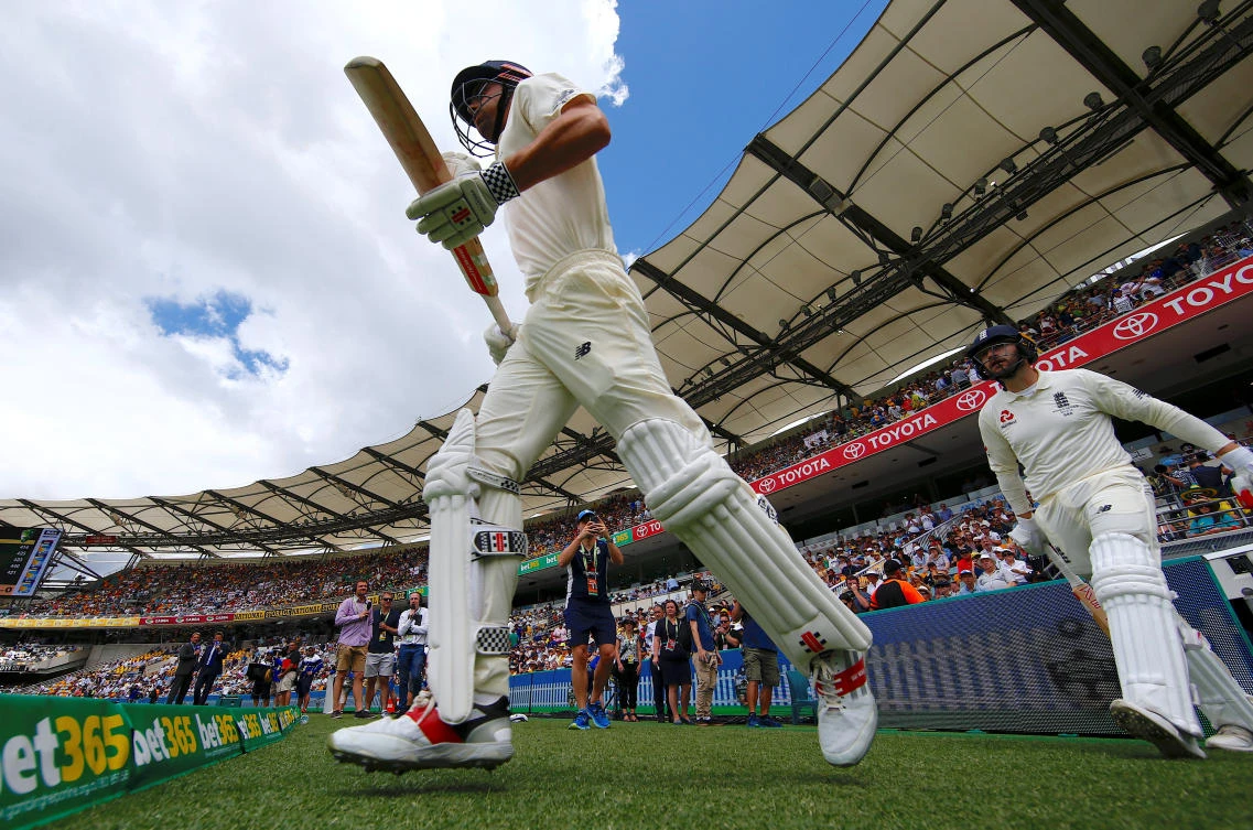 England’s opening batsmen Alastair Cook and Mark Stoneman walk onto the ground for the start of the first day of the first Ashes cricket test match. (Reuters/David Gray)