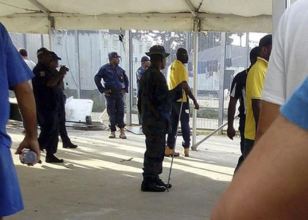 Above, police enter the immigration camp on Manus Island on Thursday, November 23. Papua New Guinea authorities on Thursday ratcheted up pressure on more than 300 asylum seekers to abandon a decommissioned immigration camp. (Refugee Action Coalition via AP)