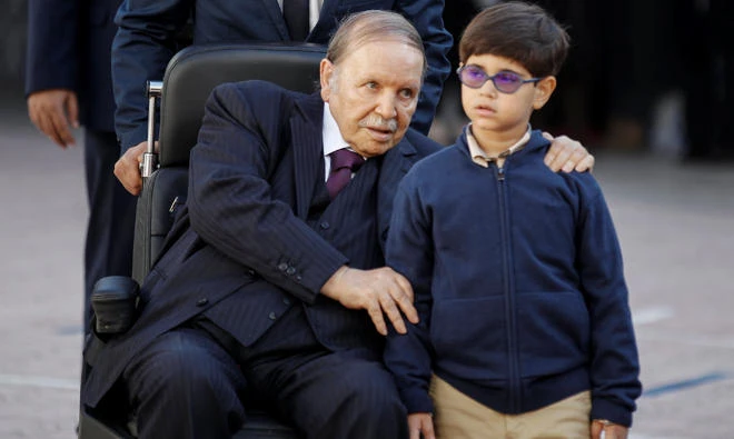 Algeria's President Abdelaziz Bouteflika is seen with his nephew after casting vote during the local elections at a polling station in Algiers, Algeria on Thursday, November 23, 2017. (Reuters)