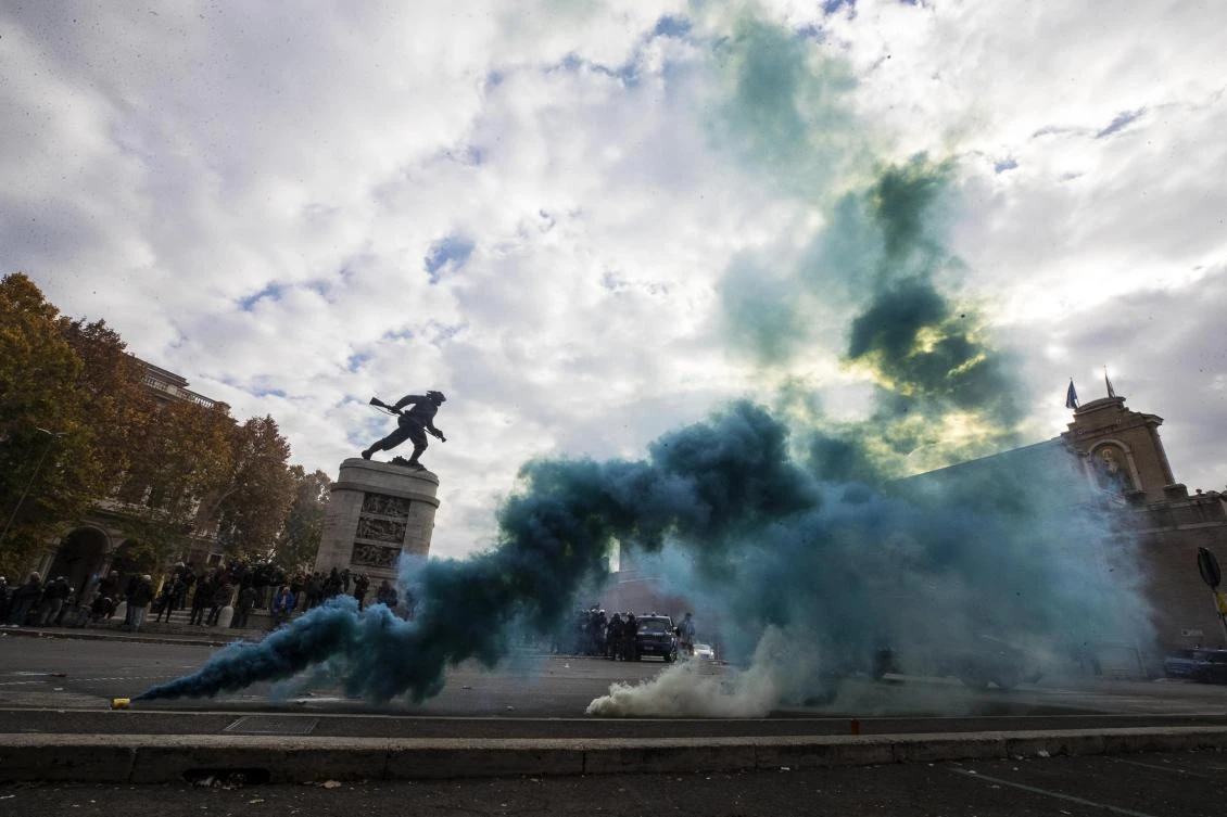 Smoke billows as taxi drivers stage a protest in front of the Italian Transports Ministry headquarters in Rome on Nov. 21, 2017. Taxi drivers across the country went on strike on that day to protest a government reform proposal that they say will deregulate the sector. (Angelo Carconi/ANSA via AP)