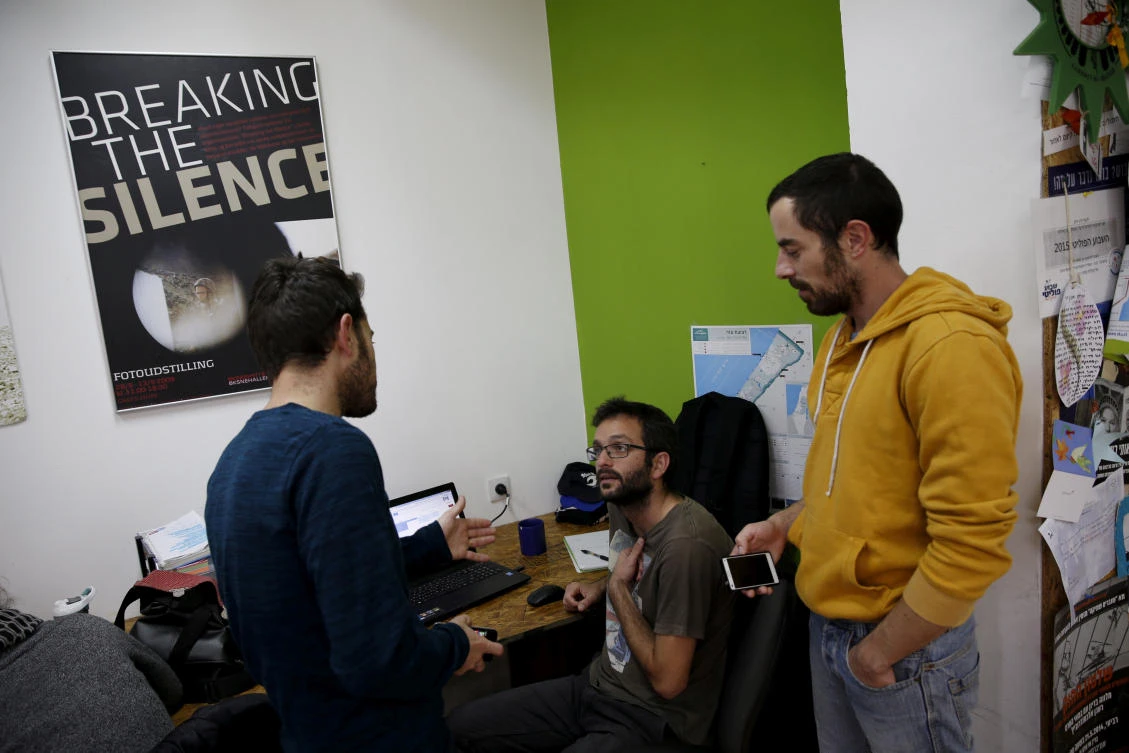 Employees work at the offices of Israeli rights group “Breaking the Silence” in Tel Aviv in 2015. Since 2004, the group has collected testimony from more than 1,100 soldiers describing the dark side of Israel’s military rule, including seemingly routine mistreatment of Palestinian civilians. (Reuters)