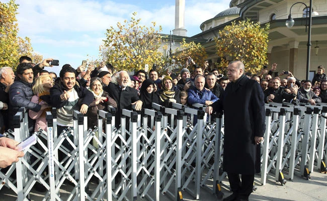 Turkey’s President Recep Tayyip Erdogan speaks with people after Friday prayers at a mosque inside his presidential palace in Ankara, Turkey, on Friday, Nov. 24. 2017. Erdogan’s office says he has discussed the Syrian crisis and other regional issues with US President Donald Trump. (Pool via AP)